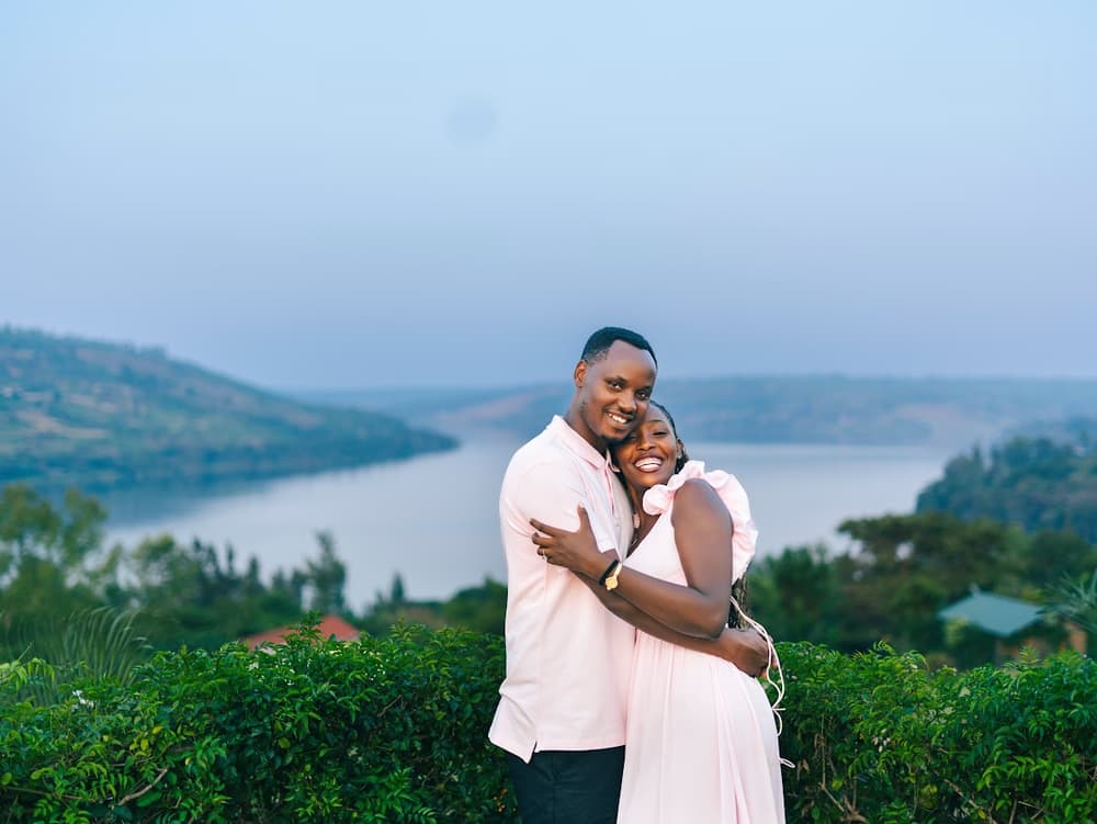 Celine and Khalim embracing above Lake Kivu at dusk